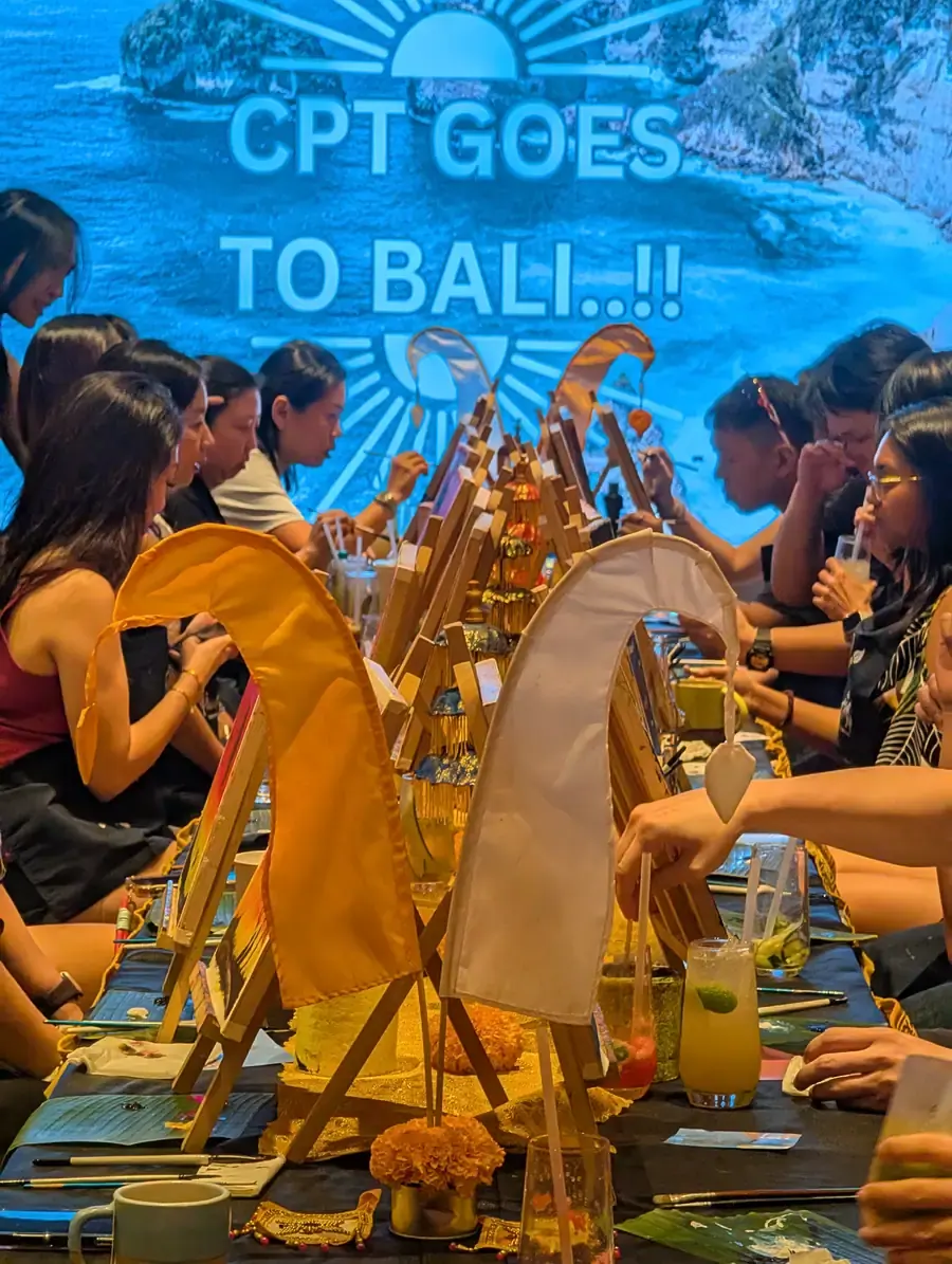 Guests painting at a private celebration with easels