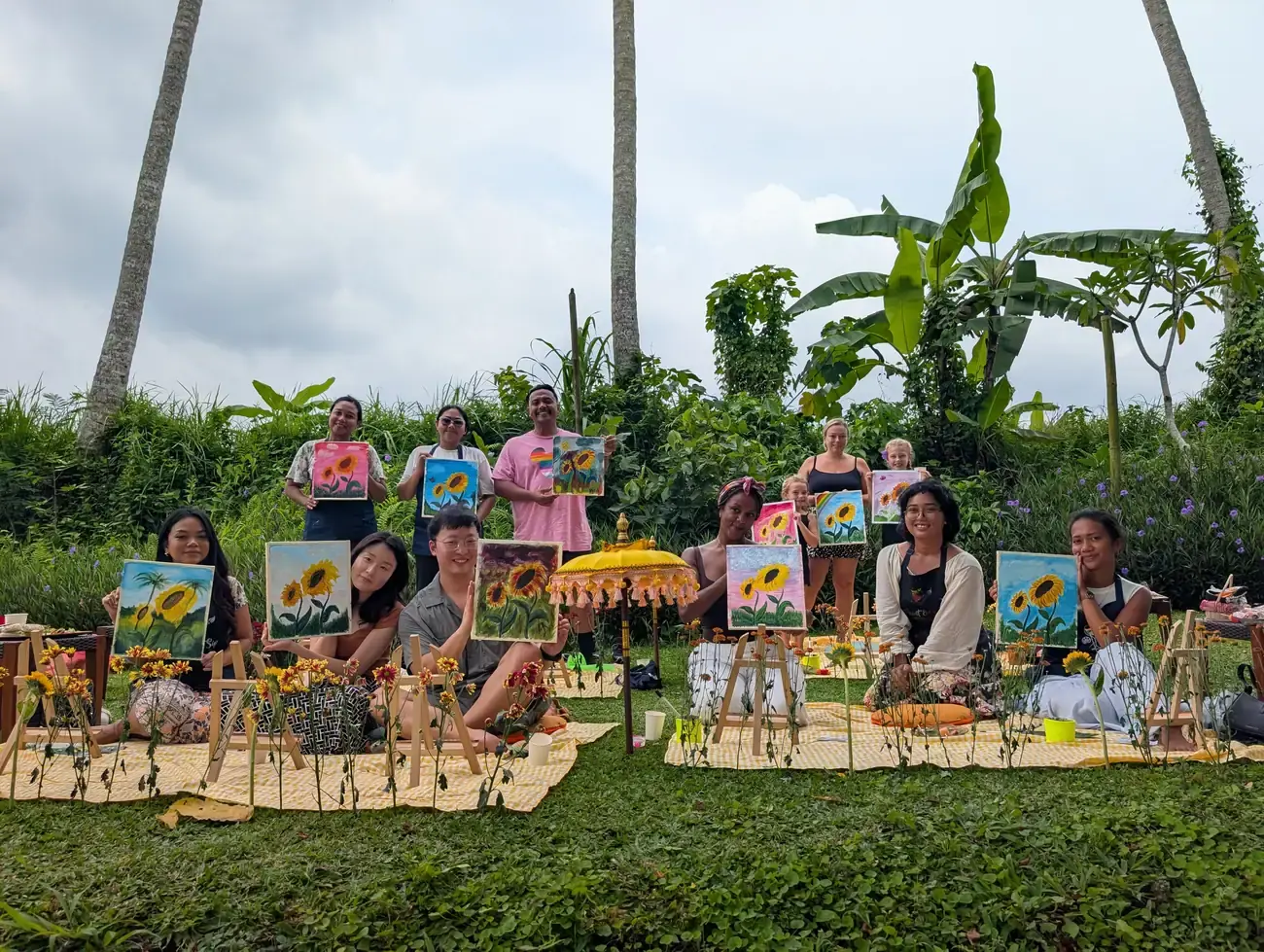 Picnic Paint and Sip setup with easels and cushions in a Bali garden