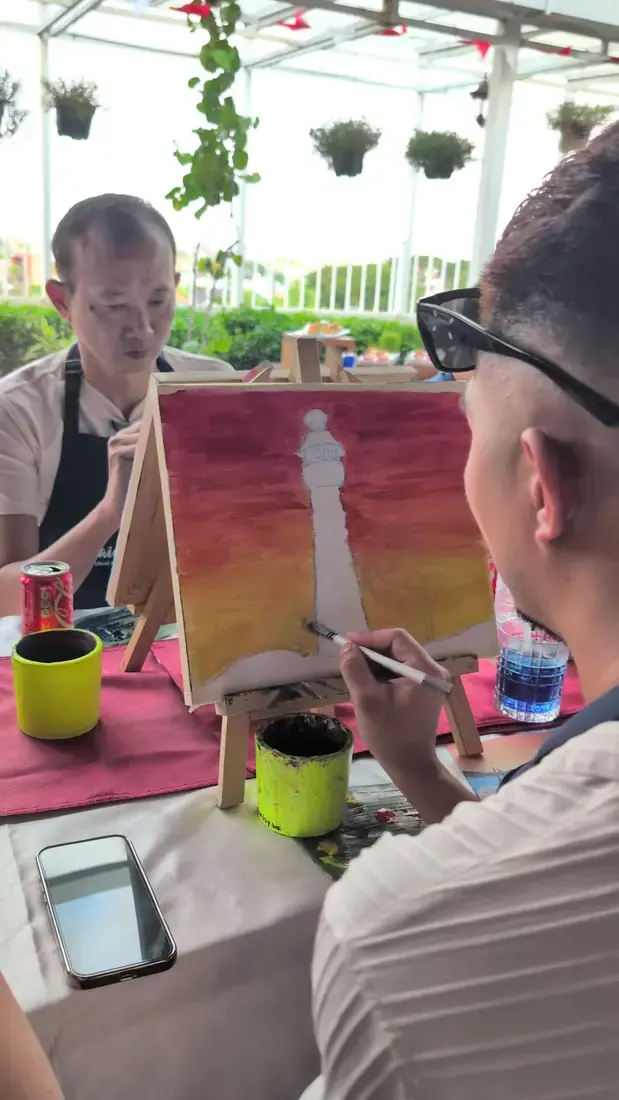Paint and sip participant creating artwork