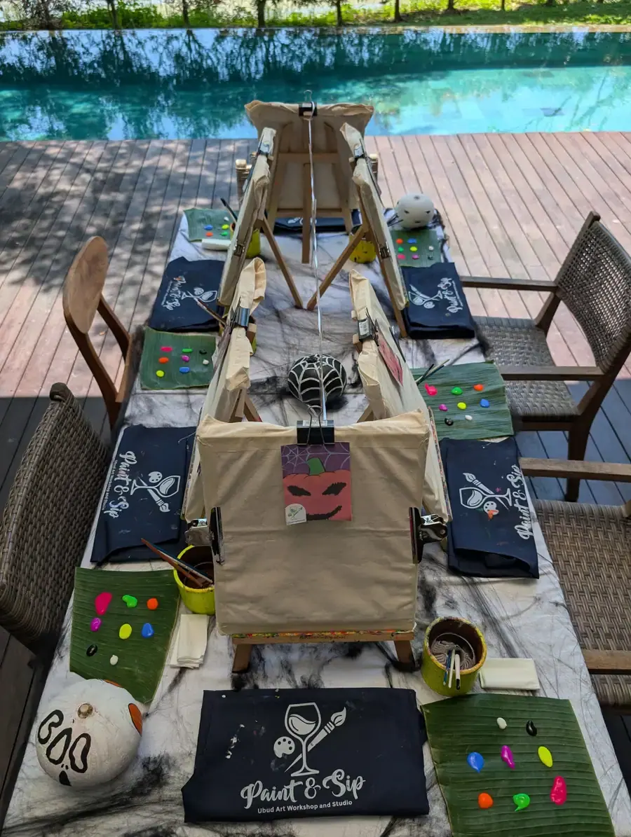 Private paint party table with tote bags, paint, and creative supplies