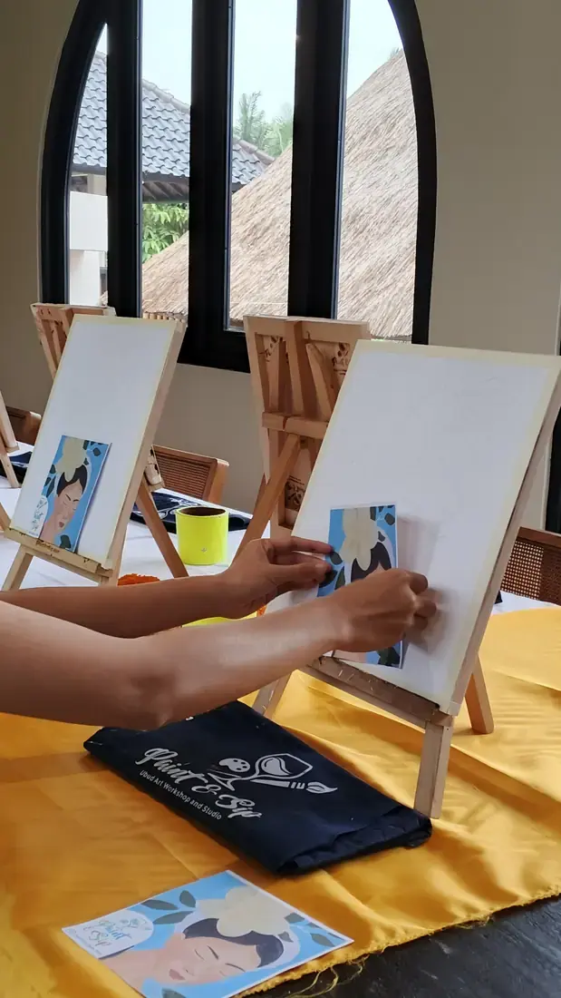 Paint and sip participant working on a colorful design