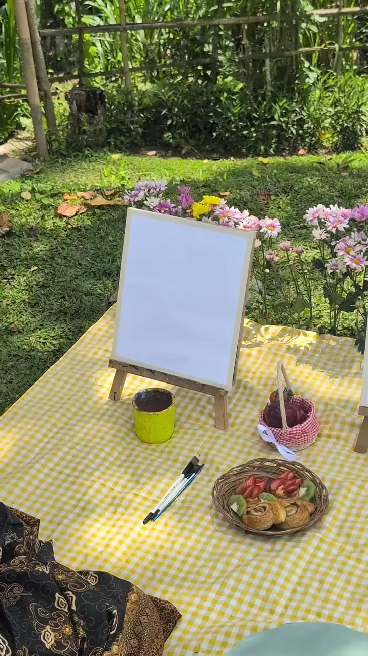 Paint and sip picnic table with art supplies and refreshments