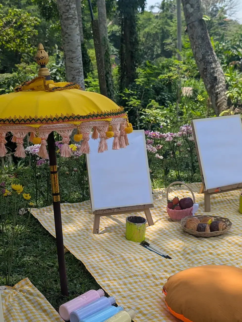 Picnic painting setup with canvas easels and garden styling