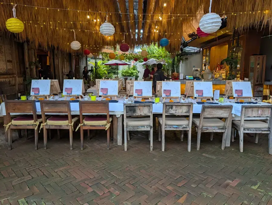 Outdoor private paint and sip setup with easels and decorations